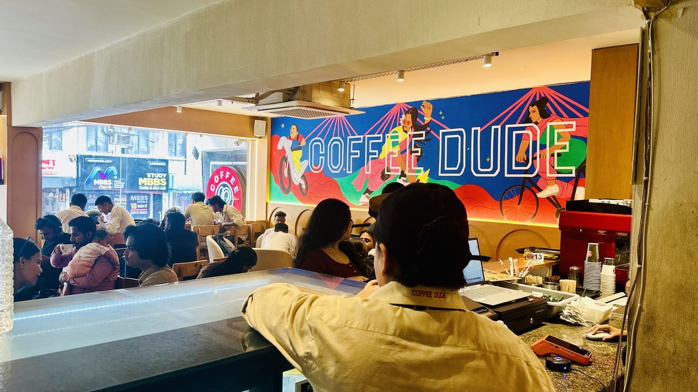 Mural and seating at Coffee Dude Hazratganj